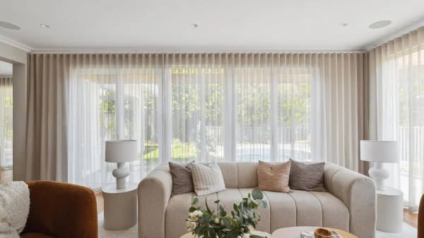 Lounge room setting with full height sheer curtains