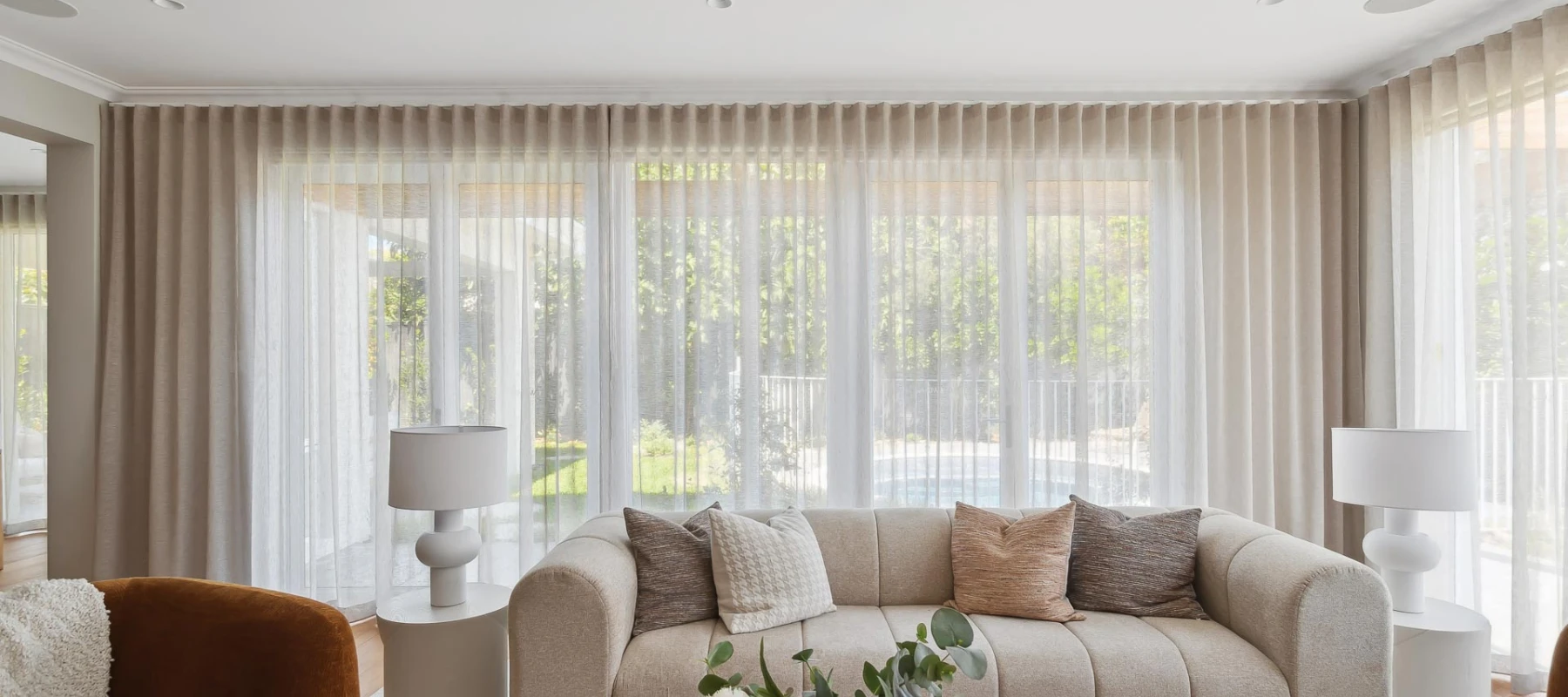 Lounge room setting with full height sheer curtains