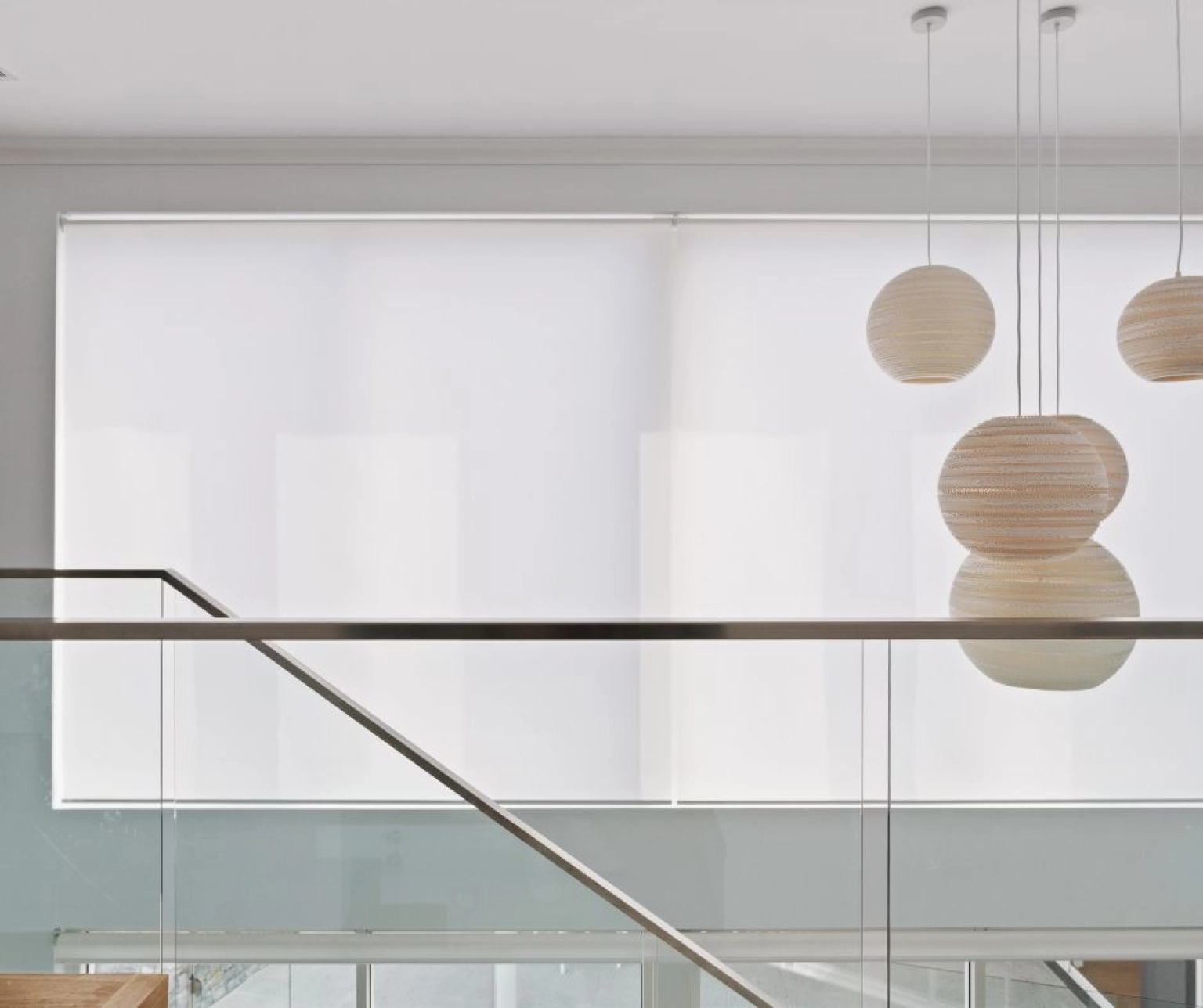 White roller blinds over upstairs window