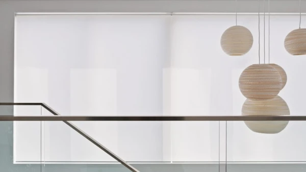 White roller blinds over upstairs window