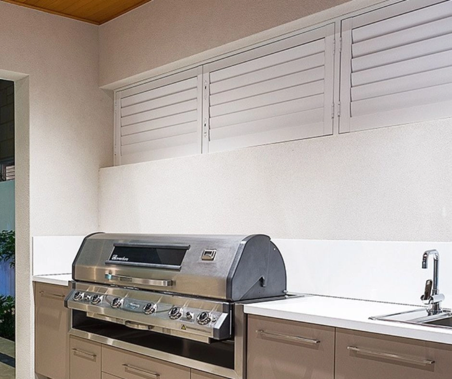 White outdoor shutters in alfresco bbq area