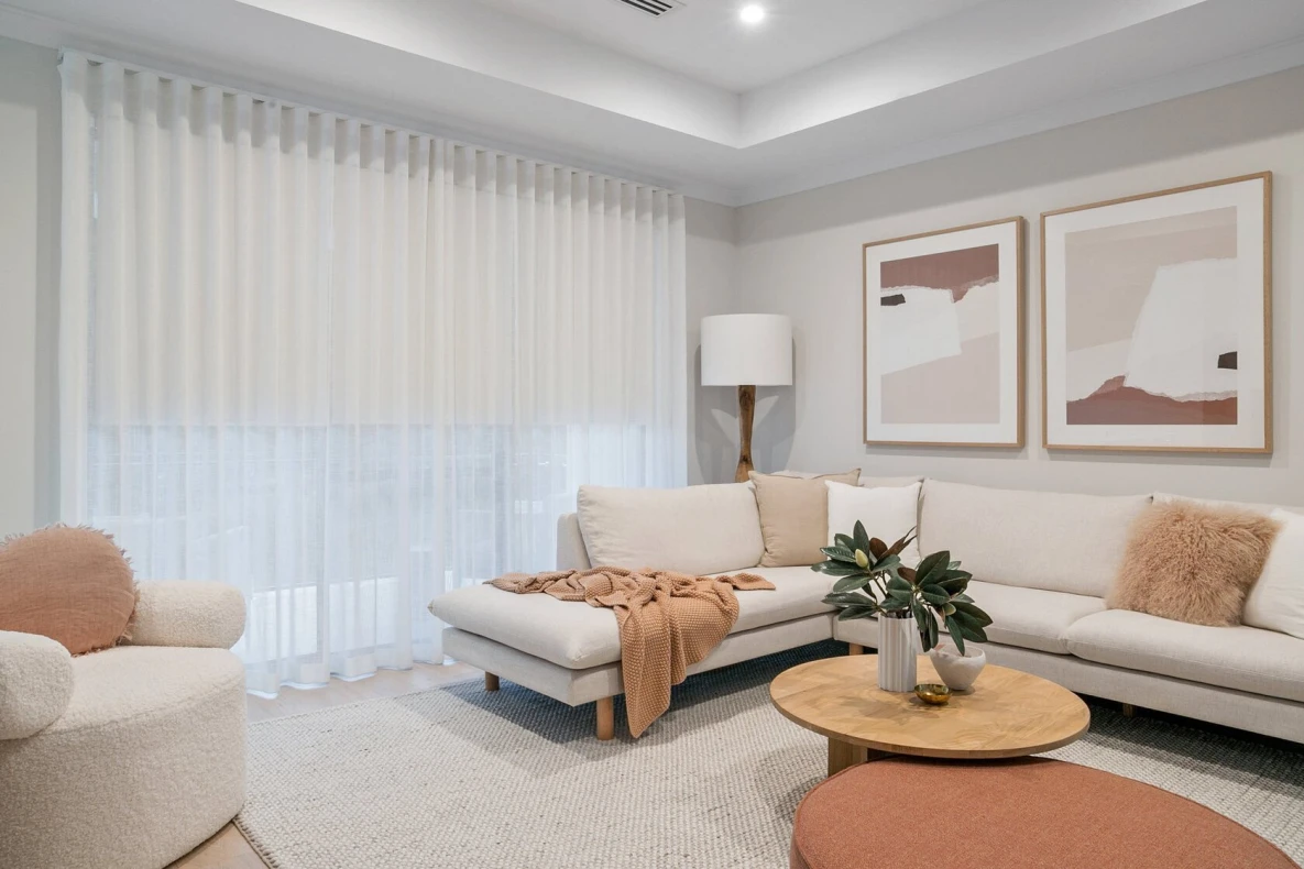 Sheer curtains hanging in a modern living room with natural light.