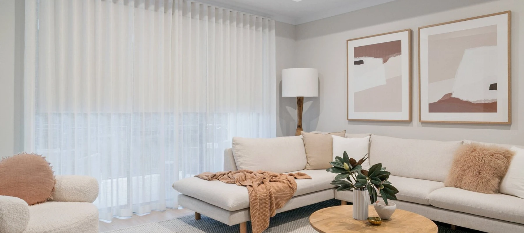 Sheer curtains hanging in a modern living room with natural light.