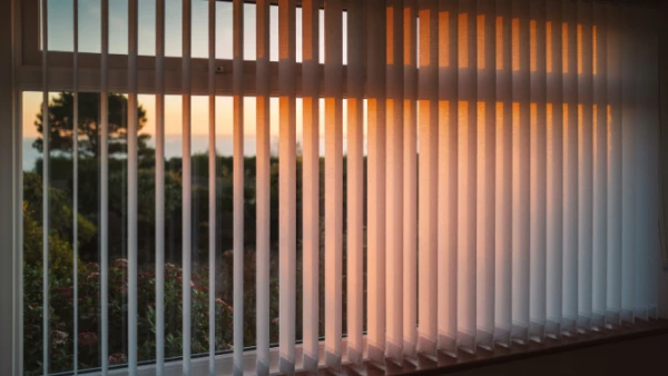 Sunset over Perth ocean through vertical blinds