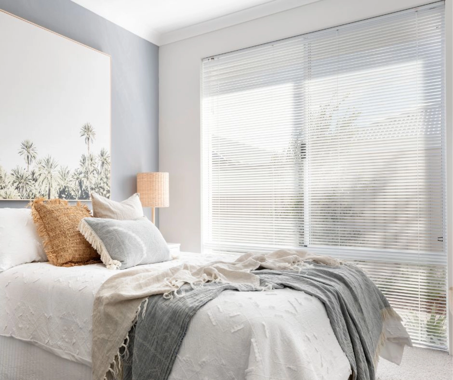 close up of white neutral bedroom with venetian blinds as focus