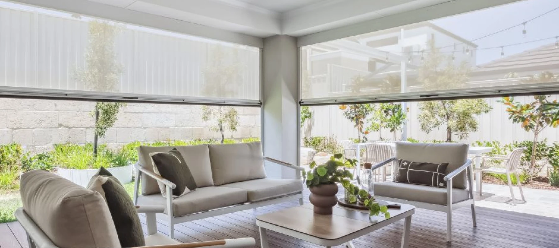 Alfresco area with ziptrak white translucent ziptrak blinds half pulled up
