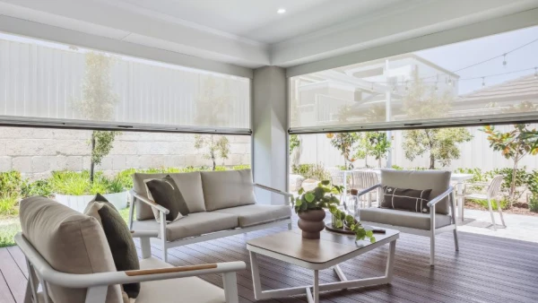 Alfresco area with ziptrak white translucent ziptrak blinds half pulled up